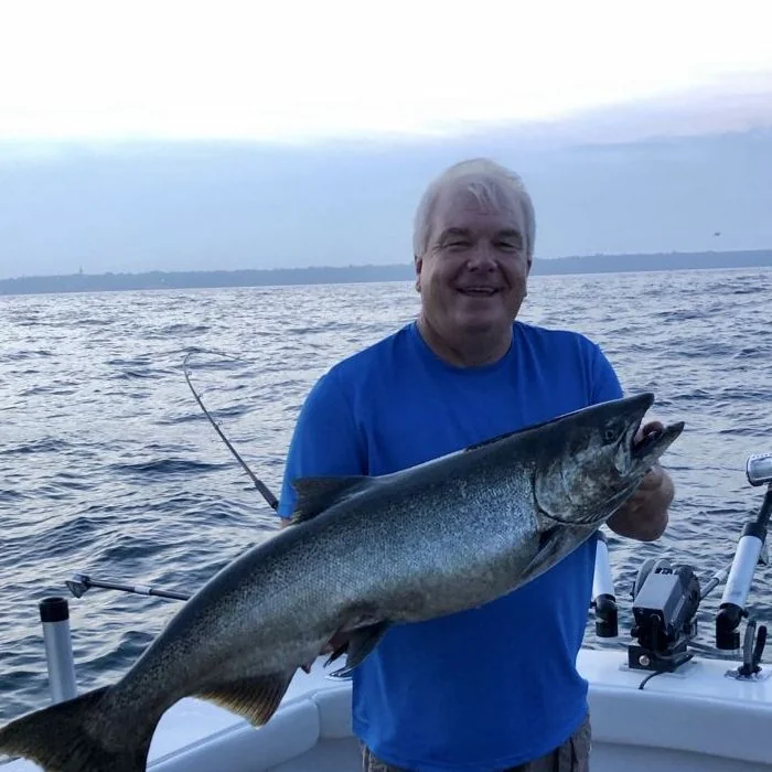 Photo of charter captain holding a caught fish
