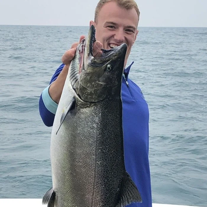 Photo of guy holding a fish they caught